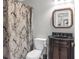 Bathroom with dark granite-topped vanity, framed mirror, and patterned shower curtain at 420 Heritage Park Nw Trce # 22, Kennesaw, GA 30144