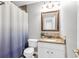 Bathroom with a vanity with granite countertop, framed mirror, and combination shower and tub at 420 Heritage Park Nw Trce # 22, Kennesaw, GA 30144