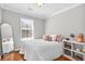Cozy bedroom with hardwood floors, natural light from window, and elegant arched full-length mirror at 420 Heritage Park Nw Trce # 22, Kennesaw, GA 30144