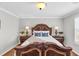 Bedroom with a large bed, bedside lamps and hardwood floors at 420 Heritage Park Nw Trce # 22, Kennesaw, GA 30144