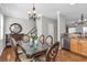 Elegant dining room with chandelier, hardwood floors, stairs and stainless steel dishwasher at 420 Heritage Park Nw Trce # 22, Kennesaw, GA 30144