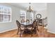 Formal dining room with hardwood floors, windows, elegant light fixture, and traditional furniture at 420 Heritage Park Nw Trce # 22, Kennesaw, GA 30144