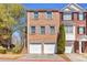 Charming townhome featuring a brick facade, double garage, and neat landscaping at 420 Heritage Park Nw Trce # 22, Kennesaw, GA 30144