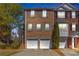 Charming townhome featuring a brick facade, double garage, and neat landscaping at 420 Heritage Park Nw Trce # 22, Kennesaw, GA 30144