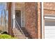 Charming front entrance with a gray door, brick exterior, and elegant floral wreath at 420 Heritage Park Nw Trce # 22, Kennesaw, GA 30144