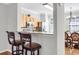Breakfast bar with decorative swivel stools looking towards stainless steel appliances at 420 Heritage Park Nw Trce # 22, Kennesaw, GA 30144