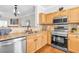 Modern kitchen featuring stainless steel appliances, light wood cabinets, and granite countertops at 420 Heritage Park Nw Trce # 22, Kennesaw, GA 30144