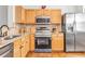 Modern kitchen featuring stainless steel appliances, light wood cabinets, and granite countertops at 420 Heritage Park Nw Trce # 22, Kennesaw, GA 30144
