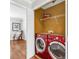Well-lit laundry area featuring a red washer and dryer set and shelving for storage at 420 Heritage Park Nw Trce # 22, Kennesaw, GA 30144