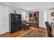 Home office with large bookshelf, secure gun safe, and a patterned area rug on hardwood flooring at 420 Heritage Park Nw Trce # 22, Kennesaw, GA 30144