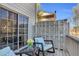 Relaxing back patio with woven chairs, throw pillows and a glass table with flowers at 420 Heritage Park Nw Trce # 22, Kennesaw, GA 30144