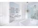 Bright bathroom featuring a freestanding tub, glass shower, double vanity, and white mosaic tiled floors at 1308 Fairview Ne Rd, Atlanta, GA 30306