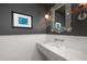 Modern bathroom with a sleek marble countertop and decorative mirror at 1308 Fairview Ne Rd, Atlanta, GA 30306