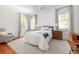 Bright bedroom with a queen bed, an office, and natural light from two windows at 1308 Fairview Ne Rd, Atlanta, GA 30306