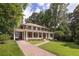 Beautiful brick home with a long driveway and manicured lawn surrounded by mature trees at 1308 Fairview Ne Rd, Atlanta, GA 30306