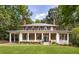 Charming two-story brick home with a full front porch, decorative columns and a lush green lawn at 1308 Fairview Ne Rd, Atlanta, GA 30306