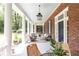 Inviting front porch with ample seating, decorative columns, and a hanging lantern at 1308 Fairview Ne Rd, Atlanta, GA 30306