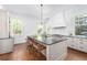 Bright kitchen features a large center island with a black countertop and wooden floors at 1308 Fairview Ne Rd, Atlanta, GA 30306