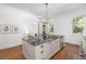 Bright kitchen features a large center island, stainless appliances, and wooden floors at 1308 Fairview Ne Rd, Atlanta, GA 30306