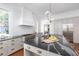 Bright kitchen features a large center island with seating, stainless appliances, and black countertops at 1308 Fairview Ne Rd, Atlanta, GA 30306