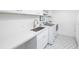 Well-lit laundry room with sleek countertops, modern appliances, and decorative flooring at 1308 Fairview Ne Rd, Atlanta, GA 30306