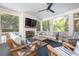 Screened porch features a fireplace, TV, and comfortable seating, surrounded by trees at 1308 Fairview Ne Rd, Atlanta, GA 30306