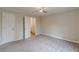 Spacious bedroom featuring neutral walls, soft carpeting, and a ceiling fan with great natural light at 5001 Oakdale Dr, Douglasville, GA 30135