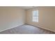 Cozy bedroom features neutral walls, soft carpeting, and a window with great natural light at 5001 Oakdale Dr, Douglasville, GA 30135