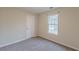 Cozy bedroom featuring neutral walls, soft carpeting, and a window with great natural light at 5001 Oakdale Dr, Douglasville, GA 30135
