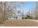 Charming single-story home featuring a carport and a well-maintained front lawn surrounded by mature trees at 5001 Oakdale Dr, Douglasville, GA 30135