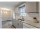 Modern kitchen featuring granite countertops, white backsplash, stainless steel appliances and hardwood flooring at 5001 Oakdale Dr, Douglasville, GA 30135