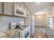 Bright and modern kitchen with granite countertops, stainless steel appliances, and access to the dining area at 5001 Oakdale Dr, Douglasville, GA 30135
