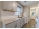 Well-lit kitchen featuring gray cabinets, granite countertops, white backsplash, and stainless steel appliances at 5001 Oakdale Dr, Douglasville, GA 30135