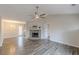 Inviting living room featuring a stone fireplace, vaulted ceiling, and modern ceiling fan at 5001 Oakdale Dr, Douglasville, GA 30135