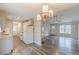 Open concept living space with modern lighting, hardwood flooring, and a stone fireplace at 5001 Oakdale Dr, Douglasville, GA 30135