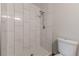 Updated shower with modern tile, rainfall shower head, and convenient seating bench at 5001 Oakdale Dr, Douglasville, GA 30135