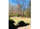 Large, fenced backyard featuring lush greenery and decorative landscaping at 917 Greymont Nw Cir, Marietta, GA 30064