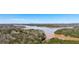 Expansive aerial view of lake surrounded by lush forests and rolling hills with blue skies at 1345 Bridgemill Ave, Canton, GA 30114