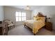 Cozy bedroom featuring a bed, window with shutters, side tables, and a wooden dresser at 1345 Bridgemill Ave, Canton, GA 30114