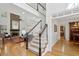 Elegant foyer with a grand staircase, hardwood floors, and a stone fireplace in the living room at 1345 Bridgemill Ave, Canton, GA 30114