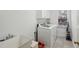 Laundry room with white washer, dryer, sink, and a convenient folding area at 1345 Bridgemill Ave, Canton, GA 30114