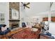 Open concept living room with stone fireplace, high ceilings, hardwood floors, and comfortable seating at 1345 Bridgemill Ave, Canton, GA 30114