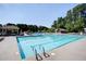 Community pool with clear water and plenty of lounge chairs, perfect for a relaxing day at 1345 Bridgemill Ave, Canton, GA 30114