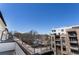 View from a townhome balcony features building rooftops and trees along the street at 345 Glen Iris Ne Dr # 5, Atlanta, GA 30312