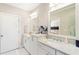 Bright bathroom featuring double vanity with white cabinets, granite countertops and a view into the bedroom at 345 Glen Iris Ne Dr # 5, Atlanta, GA 30312