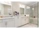 Bathroom featuring double sinks with marble countertops and a glass enclosed shower and tub at 345 Glen Iris Ne Dr # 5, Atlanta, GA 30312