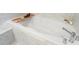 Close up of a bathtub with subway tile surround and a tray for bath accessories at 345 Glen Iris Ne Dr # 5, Atlanta, GA 30312