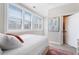 Light bedroom with shuttered windows, neutral walls, colorful rug, and an ensuite bathroom, perfect for relaxing at 345 Glen Iris Ne Dr # 5, Atlanta, GA 30312