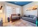A bedroom featuring a blue ceiling, a crib, and a sofa at 345 Glen Iris Ne Dr # 5, Atlanta, GA 30312