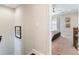 Hallway view into a primary bedroom featuring a ceiling fan, curtains, and neutral decor at 345 Glen Iris Ne Dr # 5, Atlanta, GA 30312
